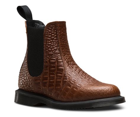 The Flora is a sleek, feminine Chelsea boot, with a slim profile in leather embossed with a faux crocodile print — bringing a next-level luxury and classic English feel. Elasticized gusset serves up a secure fit in an easy pull-on style Retains classic Doc's DNA, like grooved edges and a tonal heel-loop Built on the iconic, comfortable air-cushioned sole, with excellent slip resistance Brown Dr Martens Chelsea Boots, Brown Doc Martens Chelsea Boot, Chelsea Boots Doc Martens, Doc Marten Crazy Horse, Dr Martens Flora, Vintage Brown Doc Martens, Doc Martens Women, Dr Martens Store, Kensington And Chelsea