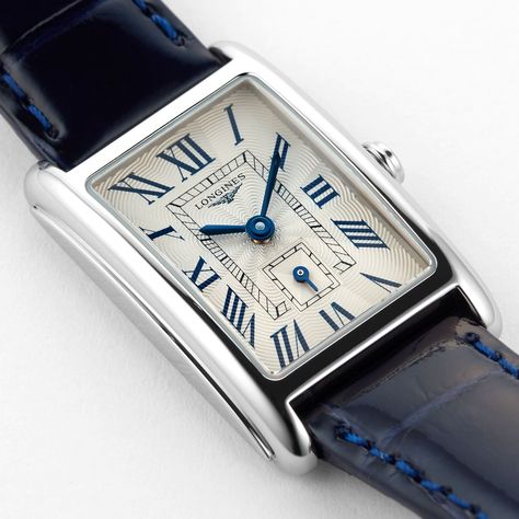 A symbol of elegance and grace Paying homage to the sweetness of life Silver-tone ‘flinque’ dial complemented by blued steel hands Rectangular stainless steel case paired with a blue leather strap Accuracy provided by the L176 quartz calibre movement ELEGANCE AND GRACEA symbol of elegance and grace, the Longines Dolce Vita collection pays homage to the sweetness of life. Inspired by the ‘Dolce Vita’, this updated collection offers a new interpretation featuring softened lines and a Longines sign Longines Dolce Vita Ladies, Longines Dolce Vita, Nasa Watch, Mens Dress Hats, Stylish Watches Men, Longines Watch, Italian Suit, Mens Casual Dress Outfits, Blue Watches