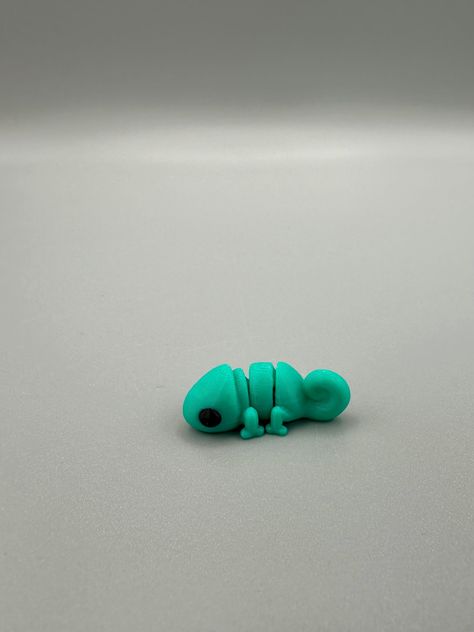 3D Printed Chameleon Fidget Toy is a cute and flexible pet toy that helps relieve stress and. #Fimo #3d_Printed_Fidget_Toy #Fidget_Toys_Diy #Mini_Clay_Ideas What To 3d Print, 3d Printed Fidget Toy, 3d Printed Stuff, Baby Chameleon, 3d Printing Toys, Break Off, 3d Printing Business, 3d Printing Art, 3d Printer Designs