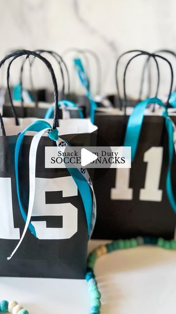 Sierra Miller | Content Creator on Instagram: "I’m on snack mom duty this weekend so you know I had to go all out! ⚽️🙈   I found these bags @hobbylobby and put each team member’s jersey # on the front. I cut the numbers with my @cricut but you could also use stickers for this part if you don’t have a cricut. To bring it all together, I added some coordinating ribbon, which really completed the look! Then, I filled it with some goodies to enjoy after the game. 😍 Being a mom is so much fun..🥹 . . . . . #soccerlife #soccermom #snackmom #soccersnacks #soccersnackideas #kidssoccer #giftideas #soccerparty #soccerpartyideas" Diy Soccer Treat Bags, Last Soccer Game Treats, Senior Night Treat Bags, Football Mom Snack Ideas, Soccer Bags For Snacks, Team Mom Soccer, Sports Snack Ideas Team Mom, Football Team Treats Goodie Bags, Soccer Team Goodie Bag Ideas