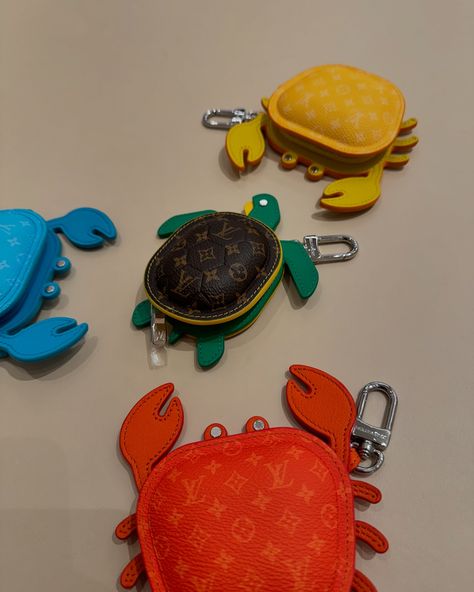 Available in four vibrant colors, this eminently giftable LV Crab Bag Charm brings an uplifting burst of summer color to a favorite bag. A beautifully crafted addition to the growing menagerie of Louis Vuitton animal charms, this playful piece is meticulously assembled from leather with an allover Monogram canvas finish to the body. Introducing the LV Turtle pouch, a fun, functional accessory. Made from Monogram canvas, colorful leather and a silver-tone snap hook, the friendly creature can... Leather Moccasins Diy, Crab Bag, Leather Charms, Diy Moccasins, Mini Accessories, Charm Chain, Keychain Design, Leather Moccasins, Summer Color