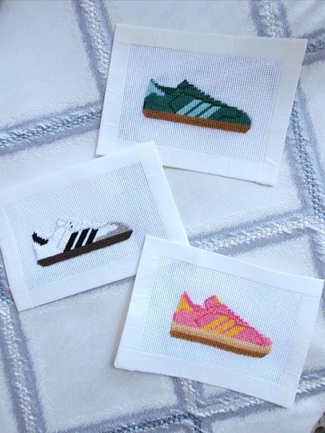 Sambas are the it shoes right now and these cute sneaker needlepoint canvases match the hype! Each samba needlepoint is painted on 18 mesh Mono Deluxe Zweigart. These cute canvases would the perfect for bag embellishments/tags, scissor fobs, or a trendy ornament.  Each canvas is hand-painted and custom options are available. Please message me or DM me @goldiemaeneedlepoint about a custom color combination to match your school, favorite team, or your own pair at home. Otherwise selected colorways are available and more are coming soon if you don't see your favorite just yet! Needlepoint Patterns Free, Needlepoint Keychain, Needlepoint Bag, Funny Needlepoint, Branding Aesthetic, Miniature Needlepoint, Scissor Fobs, Needlepoint Finishing, Needlepoint Projects