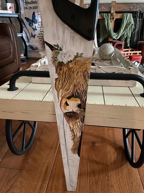 Hand painted highland cow on an old saw, painted with acrylic and then sprayed with sealer Saw Crafts Ideas, Painted Hand Saws, Old Saw Blades Ideas Paintings, Handpainted Saws, Saw Painting, Hand Saw Art Ideas, Painted Saws, Painted Wood Crafts, Summer Paintings