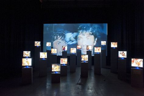 A sea of screens. Perhaps all playing back the performance at slightly different times? An overload of information. What do we actually take in? Screen Installation, September Events, Nam June Paik, Exhibition Display Design, Tv Installation, New Media Art, Leonard Cohen, Interactive Installation, Projection Mapping