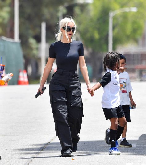 Kim Kardashian Gets Slick In Bodysuit for Saint West Soccer Game – Footwear News Body Suit Outfits Jeans Casual, Bodysuit Cargo Pants, Parachute Pants Outfit, Estilo Kim Kardashian, Sporty Chic Outfits, Versatile Sneakers, Saturday Outfit, Saint West, Kim Kardashian Outfits