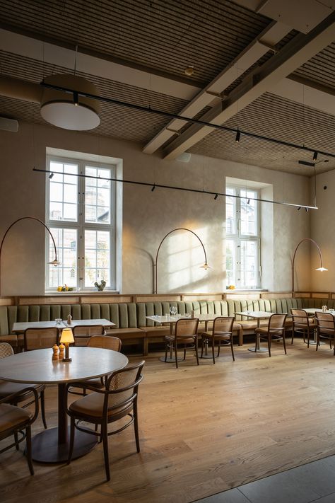 Brasserie Post is located in the old high-ceilinged post office  in Copenhagen. Troldtekt line allows the ceiling to follow the direction of the floor planks, discreetly uniting the entire room through the uniform lines and soft beige colour. Click the picture to see more.   #goodacoustics #holzwolleplatten #träullsplattor #woodwoolpanels #troldtekt | Architects: Zeso Architects, BRIQ Brasserie Interior, Copenhagen Restaurant, Acoustics Design, Bistro Interior, French Brasserie, Modern French Country, Outdoor Baths, Bar Interior Design, Cafe Table