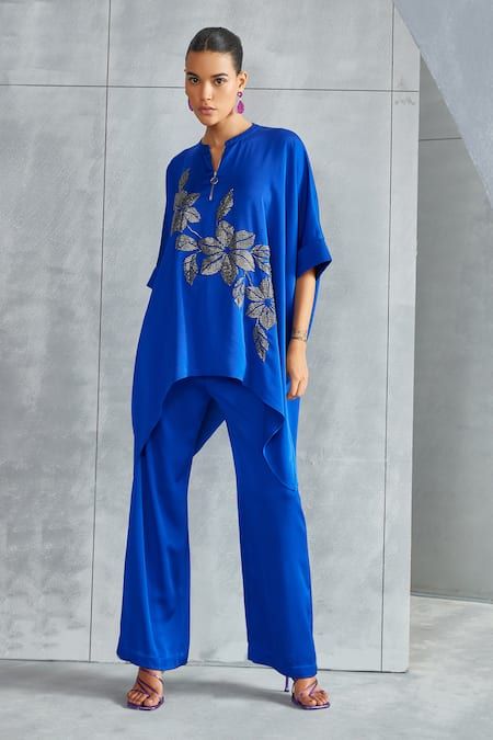 Buy Blue Satin Embellished Stone Riverleaf Floral Asymmetric Tunic For Women by Namrata Joshipura Online at Aza Fashions. Western Tops For Women, Designer Dresses Elegant, Hand Embellishment, Egyptian Blue, Asymmetric Tunic, Chic Outfits Classy, Tunics Online, Fancy Kurti, Black Floral Blouse