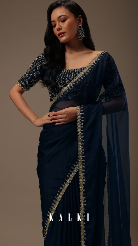 "Introducing our enchanting dark blue plain organza saree, a celebration of simplicity and opulent detailing. 
This saree showcases a cutdana border that adds a touch of elegance. The unstitched blouse fabric features heavy cutdana work all over.
EVENT - Perfect for evening parties.
The saree comes with a matching unstitched blouse." Dark Color Sarees Party Wear, Dark Colour Saree For Farewell, Dark Blue Saree For Farewell, Heavy Blouse With Plain Saree, Dark Blue Blouse Designs, Dark Color Saree, Simple Elegant Saree, Dark Saree, Grad Saree