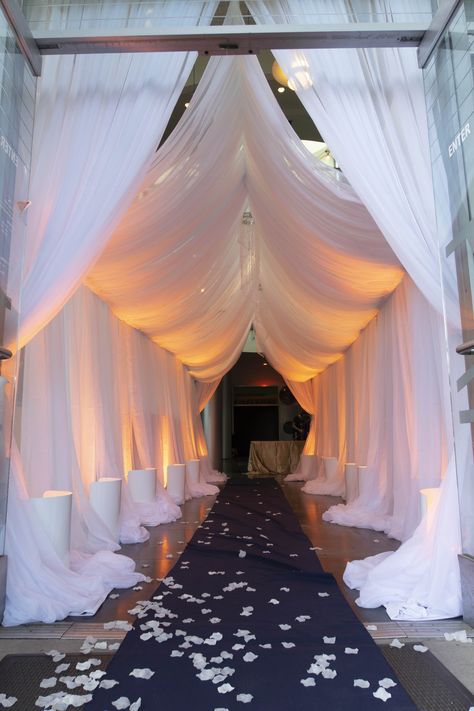 Grand Entrance for Events at Chabot Space & Science Center #Gala #Wedding #GrandEntrance #Goddess #drapes #uplight #warmsunset Party Entrance Decoration Walkways, Event Tunnel Entrance, Grand Party Decorations, Gala Night Decoration Entrance, Masquerade Entrance Decor, Main Stage Design, Party Entrance Decoration Entryway, Met Gala Prom Theme Decorations, Gala Decor Ideas