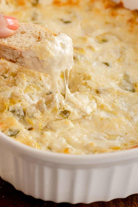 Warm and cheesy baked Artichoke Dip is a flavor-packed party classic! Chunks of artichoke hearts are baked into this creamy dip with tangy bits of jalapeno. Artichoke Dip Recipe Easy, Baked Artichoke Dip, Baked Artichoke, Artichoke Dip Recipe, Crab Dip, Artichoke Recipes, Creamy Dip, Dip Recipes Easy, Boat Food