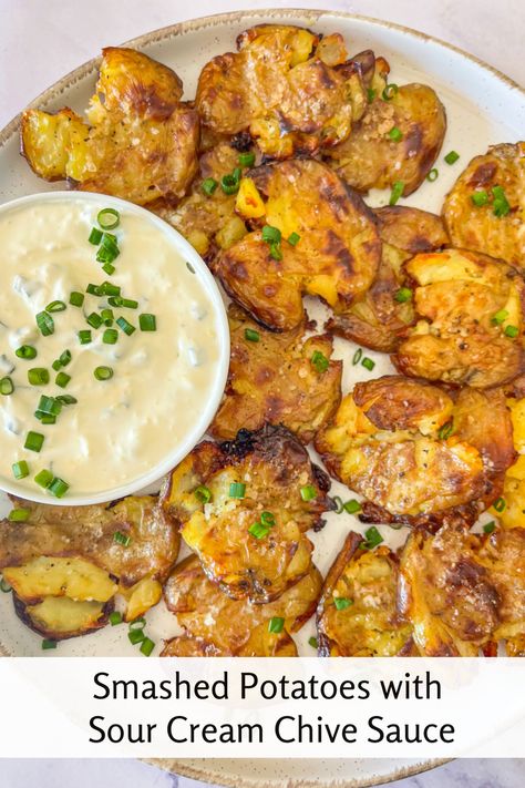 The perfect combination of crispy, golden potatoes and creamy, tangy dip! These crispy smashed potatoes are roasted until they're irresistibly crunchy on the outside while tender on the inside. Topped with a rich sour cream and fresh chive sauce, this recipe is an easy, flavorful side dish for any meal. Whether you're serving them for family dinner or a fancy holiday gathering, these crispy smashed potatoes will be the favorite. Smashed Potatoes With Sauce, Best Smashed Baby Potatoes, Smashed Small Potatoes Recipe, Sauce For Smashed Potatoes, Smashed Crispy Potatoes, Potatoes With Sour Cream, Chive Sauce, Roasted Smashed Potatoes, Sour Cream Potatoes