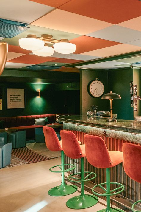 The bar of a hotel in Copenhagen that has a checkered ceiling design, with soft pink, burnt orange, and baby blue tones. he bar area is covered in an emerald green marble, gold accent lamps, and blush pink bar stools Checkered Ceiling, Martin Brudnizki, Colorful Restaurant, Copenhagen Hotel, Colored Ceiling, Suspended Ceiling, Matcha Green, Ceiling Tiles, Copenhagen Denmark