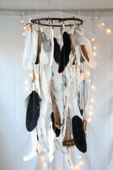 This MISTED EARTH DREAMER is a handmade dreamcatcher mobile made up of gray, black, ivory and brown feathers accented with wood and metal beads that cascade off of a natural willow branch.  The web is also adorned with a variety of metal and wood beads that compliment the coloring of the feathers. This dreamer has a very rustic and natural feel that seems to sooth and calm the ambiance of the room.    Dimensions: Willow Diameter: two sizes available -8 inches -10 inches  String Length: Feathers hang up to 21" from willow Please note, this dreamcatcher is made to order, and as all willow branches are beautiful and unique, there are slight variations in shape and coloring as that pictured.  No hardware included. Feathers may need simple hand "fluffing" after shipping. To ensure longer lastin Dreamcatcher Mobile, Diy Wall Hanging Yarn, Feather Mobile, Antler Ideas, Diy Dream Catcher Tutorial, Deer Antler Decor, Mobile Chandelier, Dream Catcher Mobile, Handmade Dreamcatcher