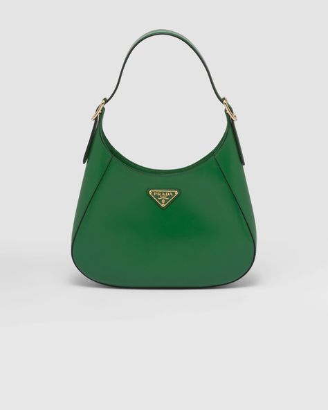 A bold and refined silhouette characterizes this leather shoulder bag with fine details. The geometric construction contrasts with soft lines to create a modern and elegant yet sporty bag, an expression of the hybrid concept and part of the Prada's aesthetic code. Prada Hobo Bag, Prada Pouch, Geometric Construction, Prada Shoulder Bag, Girly Bags, Bag Green, Prada Leather, Leather Hobo Bag, Leather Hobo