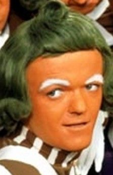 In the lead role, why not cast an Oompa Loompa?  Sure they’re prone to spontaneously break out in moralizing song, but their natural skin color will save time and money in make-up. Ok, so we’ll have to fix the green hair in post … Ompa Lumpa, Oompa Loompa Willy Wonka, Umpa Lumpa, Willy Wonka Party, Dolphin Painting, Wonka Chocolate, Gangster Style, Aqua Net, Shopping In Italy