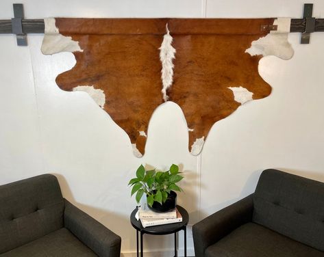 ALeatherHangs - Etsy Hang Cowhide On Wall, Cowhide Wall Decor Ideas, Goat Hide Decor, Deer Hide Wall Hanging, Animal Hide Wall Hanging, Cow Hide Decorating Ideas, Hanging Cowhide On Wall, Cow Hide Wall Decor Ideas, Cowhide On Wall