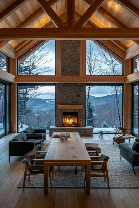 Modern Timber Frame Home With a Central Stone Fireplace and Open plan Design stunning winter mountain view through the windows. Check out and drool over all of these enchanting mountain homes with stone fireplaces–the ultimate cozy and rustic retreats.