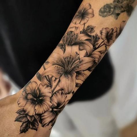 90 Awesome Lily Tattoo Designs with Meaning | Art and Design Black Lily Tattoo Cover Up, Hibiscus And Lily Flower Tattoo, Mens Lily Tattoo, Hibiscus And Lily Tattoo, Lilly Tattoo For Men, Lily Sleeve Tattoos For Women, Lilly Tattoo Men, Black And White Lily Tattoo, Lily Tattoo Men