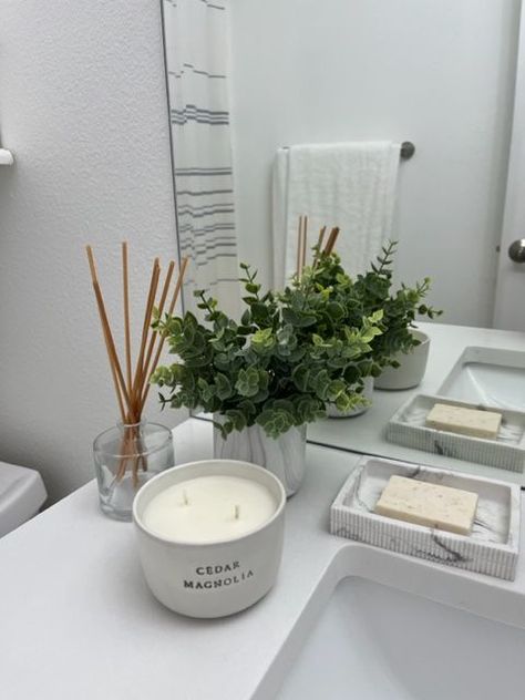 A plant can make a small bathroom feel a little larger and more sophisticated Bathroom Sink Plants, Flowers In Bathroom Decor, Small Bathroom Plant Ideas, Plain Bathroom Decor, Small Plants For Bathroom, Bathroom Flowers Decoration, Small Bathroom Sink Decor, Decorate Bathroom Ideas, Plant Bathroom Aesthetic