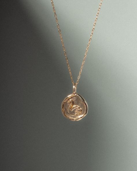 "Introducing The Leda Necklace -- the swan, a signature Elysian Theory motif, symbolizes beauty, loyalty, grace, and elegance. The coin inspired pendant was hand-carved in wax, and cast into recycled yellow bronze.  - Choose from a 14k gold-filled chain, adjustable from 16-18\", or a beaded pearl necklace that is adjustable from 15-16\". - To operate more sustainably, we don't keep a large inventory of pieces and prefer to have these pendants cast in small batches. Each item is made-to-order. Pl Bridal Party Earrings, Swan Jewelry, Beaded Pearl Necklace, Swan Pendant, Swan Necklace, Bronze Necklace, Gold Jewelry Simple, Party Earrings, Jewelry Lookbook