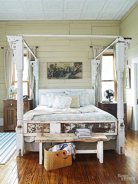 These homeowners saw a whole much greater than the pile of salvaged house parts awaiting their creative hands. Victorian Era porch columns complete with spandrel details stand as posters for the bed frame; a flat door becomes the headboard; and a sidelight inset with tin ceiling panels crafts a mighty fine footboard. Pieces of reclaimed wood create a canopy that completes the bedstead's timelessly appealing four-poster silhouette. Antique Door Headboards, Door Headboard, Rustic Bedroom Design, Reclaimed Doors, Porch Columns, Rustic Room, Four Poster, Wood Bed Frame, Antique Wood