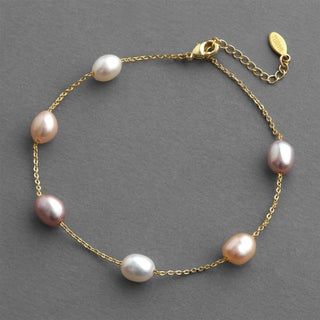 This stunning 'floating pearl' bracelet features lustrous genuine champagne multicolor freshwater pearls on a delicate chain. It has a lighter-than-air silhouette and a blend of 3 natural pearl tones that give this delicate bracelet a romantic style. Adjustable from 6 ¾" to 8 ¼" for the perfect fit. Plated in genuine 14 karat yellow gold. Matching shoulder duster earrings Shoulder Duster Earrings, Jewelry Gift Guide, Bridal Tops, Special Occasion Jewelry, Bridal Fashion Jewelry, Handmade Fashion Jewelry, Bridal Bracelet, Beaded Bracelets Diy, Natural Pearl