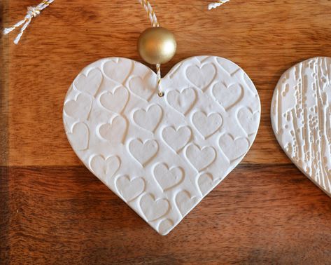 You will receive the 3 heart shaped tree ornaments in the photos. These are made of Plaster of Paris and are my own original design. Each one has a different design embossed on the front only. I made these by using rubber stamps and various elements from nature, like leaves and branches from my garden. So pretty and delicate. Each has a gold sparkly hanging cord and a metallic gold painted wood bead as well.These are also a gorgeous upgrade to your present-giving game! Add an ornament to the bow Heart Shaped Tree, Paris Crafts, Clay Gift Tags, Clay Christmas Decorations, Metallic Gold Paint, Heart Christmas Ornaments, Polymer Clay Gifts, Leaves And Branches, Polymer Clay Ornaments