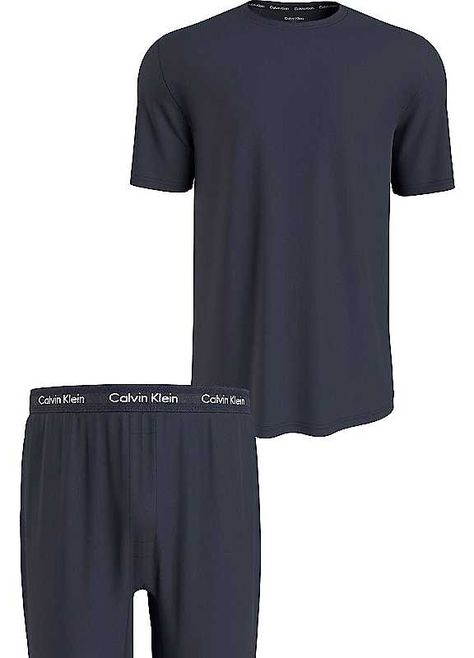 Introducing Calvin Klein's Pyjama Sets, the ultimate loungewear for any modern man. Made with a comfortable cotton mix fabric, these shorts are designed for both comfort and style. Featuring the iconic Calvin Klein logo, these pyjamas are a must-have for any fashion-forward individual. With a classic short-sleeved, round neckline design, this set offers a basic shape that is perfect for everyday wear. Upgrade your sleepwear collection with Calvin Klein's Pyjama Set and experience the perfect blend of comfort and sophistication. Available in a range of sizes for men, these pyjamas are the ideal choice for a good night's rest.Brand: Calvin KleinMachine wash95% Cotton, 5% Elastane Calvin Klein Pajamas, Pyjama Sets, Neckline Designs, Basic Shapes, Pyjama Set, Mixing Fabrics, Modern Man, Nightwear, Round Neckline