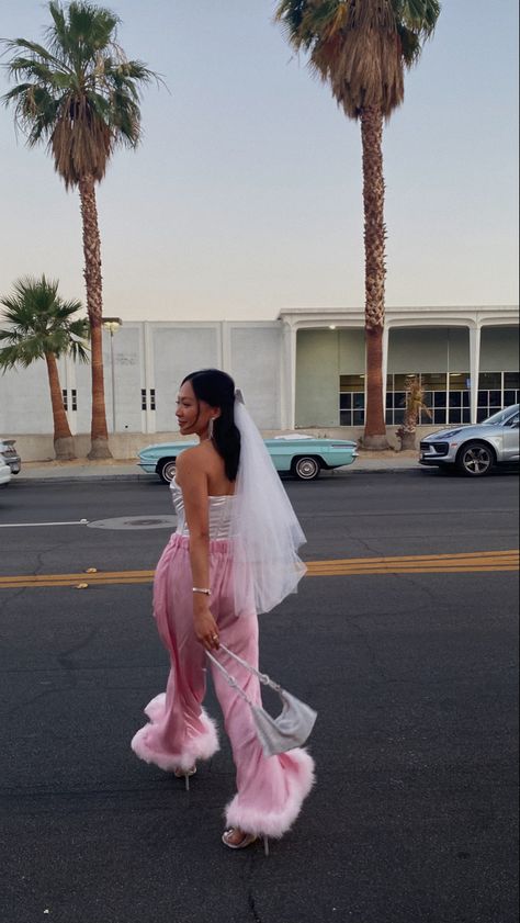 Sunset photo backdrop featuring a bride to be in pink feather trimmed pants and bow veil Unique Bachelorette Outfits, Black Bride Bachelorette Outfit, Barbie Bride Outfit, Barbie Bachelorette Outfit, Barbie Bride Bachelorette Outfit, Bach Outfits For Bride, Vegas Bachelorette Outfits, White Barbie Outfit, Palm Springs Bachelorette Outfits