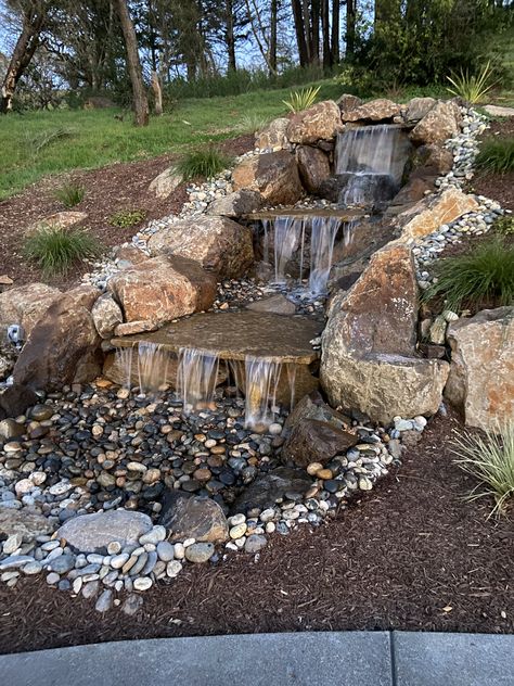 Hillside Waterfall And Pond, Unique Pond Waterfall Ideas, Man Made Waterfalls Backyard Landscaping, Large Pond Waterfall Ideas, Rock Waterfalls Backyard, Waterfall Stream Backyard, Waterfall Diy Backyard, Backyard Pond Waterfall, Garden Waterfalls Ideas Landscaping