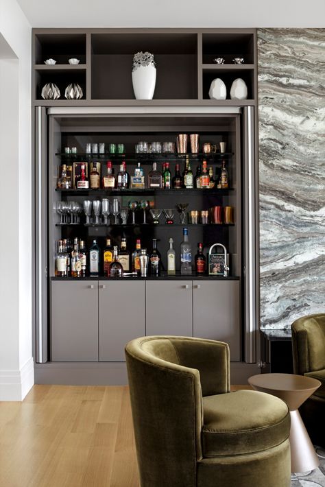 This custom wet bar features built-ins, able to be hidden behind doors. Hidden Bar Cabinet Built Ins, Home Bar Hidden, Hidden Bars At Home, Hidden Bar Cabinets For Home, Hidden Bar In Living Room, Hidden Home Bar Ideas, Hidden Bar Unit In Living Room, Built Ins With Bar, Bedroom With Bar