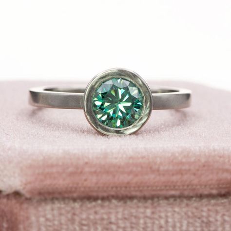 Effortlessly elegant and forever stylish, this Minimal Round Green Moissanite Wide Bezel Low Profile Solitaire Platinum Engagement Ring is a dream come true! Crafted with a contemporary low profile design in luxurious platinum, this stunning ring is a true symbol of modern sophistication. The captivating green moissanite center stone will leave you breathless, making a statement that lasts a lifetime. Elevate your engagement with this exquisite piece! Tap the link in our bio to discover more ... Green Moissanite, Stunning Engagement Rings, Platinum Engagement Ring, Engagement Rings And Wedding Bands, Stunning Engagement Ring, Bezel Ring, Platinum Engagement Rings, Profile Design, Low Profile