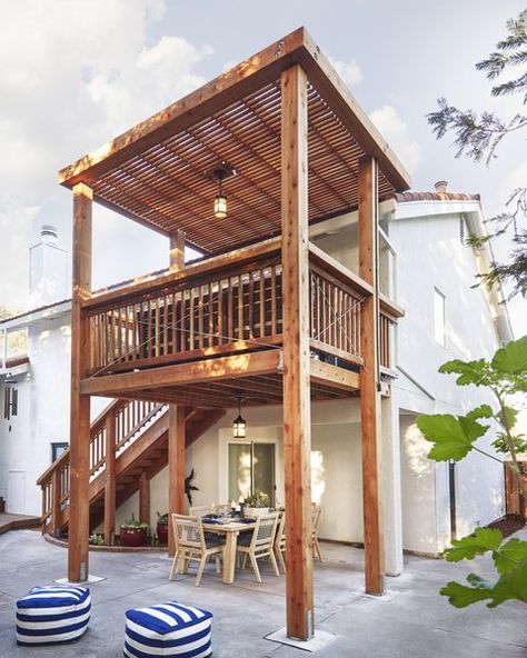 Outdoor, Wood Fences, Wall, Vertical Fences, Wall, Back Yard, Wood Patio, Porch, Deck, Trees, Shrubs, Hanging Lighting, and Large Patio, Porch, Deck Soria redesigned his parents' two-story deck with wood sourced from Humboldt Redwood. Photo 2 of 9 in An Elegant Redwood Deck Transforms the Exterior of a ‘70s Home Redwood Deck, Redwood Decking, Wood Fences, Terrasse Design, Large Patio, Patio Deck Designs, Hanging Lighting, 70s Home, Pergola Design