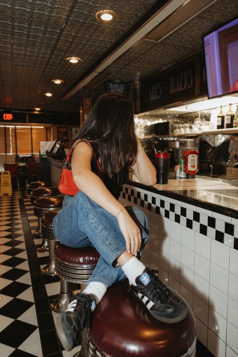 diner , black sambas, red bag, red coach bag, jeans, black and white checkered floor, old school diner Vintage Diner Photoshoot, Diner Aesthetic Photoshoot, Retro Diner Photoshoot, Old School Diner, Black And White Checkered Floor, Diner Photoshoot, Red Coach Bag, Black Sambas, Photo Vintage Retro