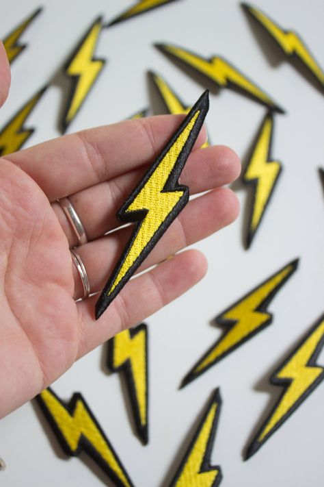 "Lightning Bolt Patch Spark up your denim. Use this patch for an instant update on just about anything!  WildRose patches come with iron-on backings & ship with instructions.  * Measures approx. 3\" by 1.5\" * Iron on backing; ships with instructions * Designed by WildRose NY" Bolt Crafts, Yellow Starburst, School Jacket, Full Metal Jacket, Black Unicorn, Spark Up, Saint James, Embroidery Patches, Moon Child