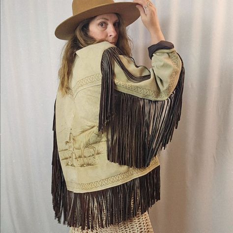 Draped in the spirit of the wild, this Mexican horse suede fringe jacket carries the untamed West on its back. Etched horses gallop across the leather, their freedom mirrored in the flowing fringe that sways with every step. Crafted with a nod to the desert sun and open skies, it speaks of rugged journeys and uncharted paths. The hand-carved details are as bold as they are timeless, a wearable work of art. The jacket's warmth embraces you like the arms of the earth, grounding yet setting you ... Untamed Heart, Boho Soul, Horse Galloping, Suede Fringe Jacket, Free Spirit Style, Wild Spirit, Fringe Jacket, Suede Fringe, Suede Jacket