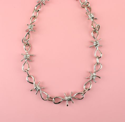 Show off your punk style with this one-of-a-kind barbed wire necklace! Our design features an ultra-thick barbed wire construction, making it the perfect accessory for anyone looking to stand out from the crowd. Load up that neckline with some punk -- you won't regret it! Measures 18 inches/46cm long Links measure 4.5cm wide x 1.9cm long each. Barbed Wire Jewelry, Shifting Hogwarts, Barbed Wire Necklace, Dude Style, Chain Tattoo, Hogwarts Dr, Xmas List, Better Things, Wire Necklace