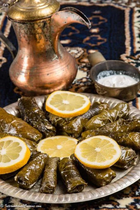 Qatari warak enab are little bundles of grape leaves stuffed with lamb and millet. The lamb adds a lovely sweetness to them and they make a lovely appetizer for any occasion. This recipe is also #plantparadox friendly. #Qatar #warakenab #qatarifood #qatarirecipe #stuffedgrapeleaves #internationalcuisine #internationalfood #worldfood Warak Enab, Grape Leaves Recipe, Jordanian Food, Stuffed Grape Leaves, Plant Paradox, Middle Eastern Dishes, New Year's Food, Ground Lamb, Global Recipes