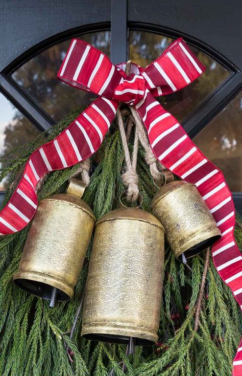 The perfect Christmas bells to hang on your front door! #bells #christmasdecor #christmasdecorating Cow Bell Decor, New England Christmas, Holiday Door Decorations, Diy Christmas Door, Christmas Door Decoration, Driven By Decor, Front Door Christmas Decorations, Bell Decorations, Christmas Front Doors