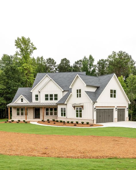 Welcome to the heart of charm! 🌟 Step into this delightful white home, where the gentle hue of brick accents, lush landscaping, and exposed wooden details create a story of timeless warmth. The rich-toned garage adds a touch of cozy sophistication, making every corner picture-perfect!   Builder @restorebuildanddesign   Design @hawkinsandgraydesign   Photo @lyndseymariephotography   Cabinetry @luxecabinetryanddesign    Décor @wilsonhomedecor White And Wooden House Exterior, White Farmhouse With Brick, Farmhouse With Brick, Two Story White Brick House, White Brick House, Two Tone House Exterior, White Siding House, Grey Brick House Exterior, White Siding Exterior