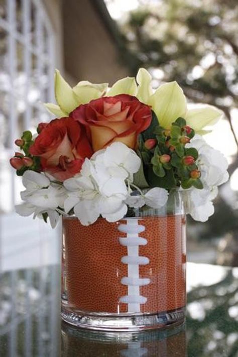 football centerpieces for tables | We really love this clear vase football centerpiece and the lovely ... Football Party Centerpieces, Baby Shower Centerpieces For Boys, Football Centerpiece, Football Centerpieces, Banquet Centerpieces, Grooms Table, Football Banquet, Football Wedding, Football Baby Shower