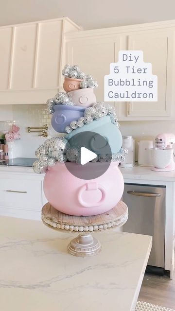 Trish 💕 Beautiful Lifestyle Blogger on Instagram: "DIY 5 Tier Bubbling Cauldron 🫧 ✨ Comment “bubbling cauldron” for the links! Last year I made a giant 3 tier bubbling cauldron and this year I thought I’d make smaller version with 5 cauldrons! I think it turned out so cute! Tag me if you make one! I can’t wait to see yours! 
.
.
#cauldron #diy #halloween #halloweendecor #halloweenvibes #halloweendiy #cutehalloween #spooky #spookyseason #spookyszn #spookycute #pink #pinkhalloween #pastel #pastelhalloween #pastels #pinkpinkpink #pinkaesthetic #pinkdecor #pinkhome #pinterest #homegoods #amazon #diycrafts #diycraft #diyprojects #diyhomedecor

Comment SHOP below to receive a DM with the link to shop this post on my LTK ⬇ https://liketk.it/4MzGe

DIY 5 tier bubbling cauldron 🫧⭐️ #ltkseasonal Pastel Halloween Food, Pink Halloween Diy, Giant Cauldron, Cauldron Dessert, Candy Cauldron, Disco Cauldron, Bubbling Cauldron Diy, Cute Cauldron, Disco Ball Witches Cauldron