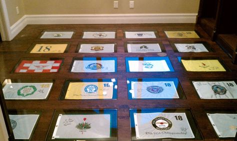 My dad ran out of wall space for his collection of golf pin flags, so I told him to put them under industrial-strength glass in the floor. We're pretty pleased with the results. Framed Golf Flag Display, Golf Flag Display Ideas, Golf Flag Display, Flag Display Ideas, Hunting Rooms, Golf Flags, Golf Office, Sports Cave, Golf Bar