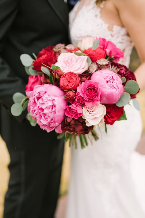 This red and pink wedding was filled with so many gorgeous blooms. From deep reds to blush this was over the top.  Sometimes we don't know the cost of bridal bouquets- this baby goes for $350+ based on garden roses and peonies highlighting this luxury look. Pink Red And White Flowers, Pink And Red Bouquet Wedding, Red And Pink Bridal Bouquet, Pink And Red Wedding Bouquet, Bright Pink Wedding Theme, Red And Pink Bridesmaid Dresses, Pink Table Centerpieces, Pink And Red Wedding Flowers, Red And Pink Wedding Flowers