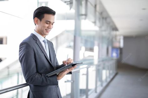 Premium Photo | Young asian business man holding a tablet looking away , smart business concept. Asian Business Man, Investment Analysis, Smart Casual Wear, Report Writing, Business Performance, Smiling Man, Smart Business, Learning Courses, Business Investment