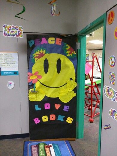 My hippie smiley face door cover for "Peace, Love & Books" Scholastic Book Fair Smiley Face Classroom Door Ideas, Smiley Face Bulletin Board Ideas, Bookfair Themes, Hippie Classroom, Gym Door, Ra Decorations, Smiley Art, Groovy Theme, Retro Door