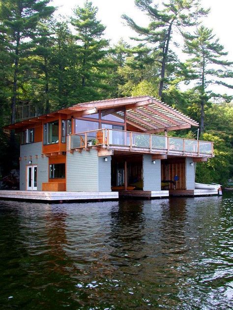 This one has a boat garage underneath. | 28 Houseboats That Will Make You Want To Float Away Floating Dock Plans, Boathouse Design, Boat Garage, Dock House, Floating Homes, Houseboat Living, Boat Docks, Floating Architecture, Lakefront Living