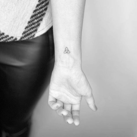 Minimalist triquetra tattoo on the wrist Celtic Knot Tattoo Minimalist, Minimalist Norse Tattoo, Irish Simple Tattoos, Minimalist Celtic Tattoo, Small Celtic Knot Tattoo, Dainty Celtic Tattoo, Celtic Knot Tattoo For Women, Triquetra Tattoo Women, Ireland Tattoo Ideas