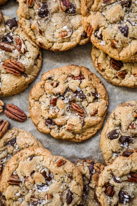 Brown Butter Pecan Chocolate Chip Cookies have a crispy-chewy texture, the irresistible crunch of pecans, and the rich sweetness of chocolate chips. Made with toasty brown butter for a touch of warmth, these cookies are topped with a sprinkle of flaky sea salt, elevating their flavor to new heights. Brown Butter Pecan White Chocolate Chunk Cookie, Carmel Pecan Chocolate Chip Cookie, Chewy Oatmeal Pecan Cookies, Brown Butter Pecan White Chocolate Chunk, Chocolate Praline Cookies, Brown Butter Walnut Cookies, Oatmeal Pecan Chocolate Chip Cookies, Chocolate Chip Molasses Cookies, Pioneer Woman Chocolate Toffee Crunch Cookies