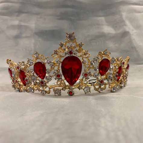 This Crown Features A Gold Tone With Beautiful Red Jewel Accents. Red And Gold Tiara Quince, Quince Crowns Red And Gold, Red And Gold Quinceanera Theme Tiara, Quince Crowns Flowers, Red Black And Gold Dress, Red Quinceanera Tiara, Dark Red Quinceanera Crown, Burgundy Quinceanera Crown, Red And Gold Quinceanera Crown